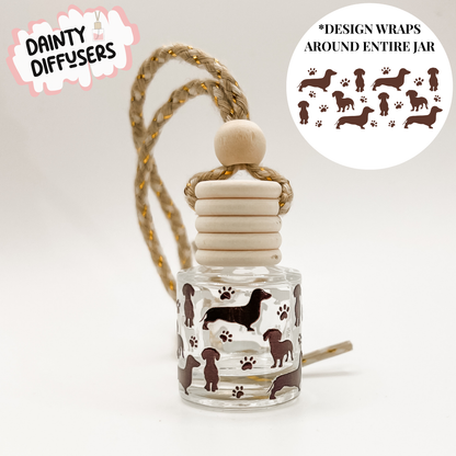 Glass diffuser with dachshund design on a white background, featuring 'Dainty Diffusers' branding.